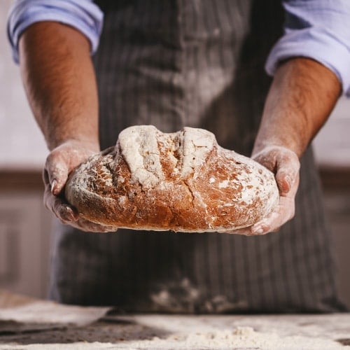 baker with loaf of bread