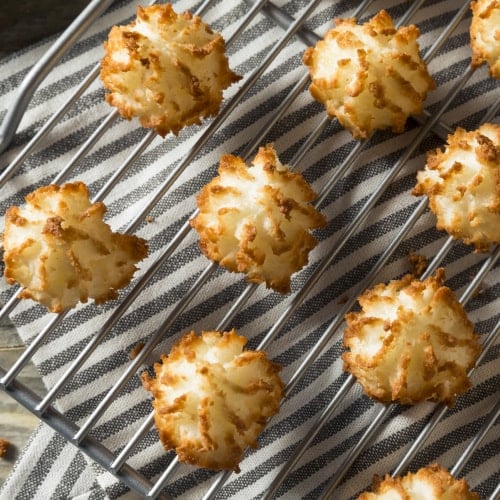 a batch of coconut macaroons on a cooling rack