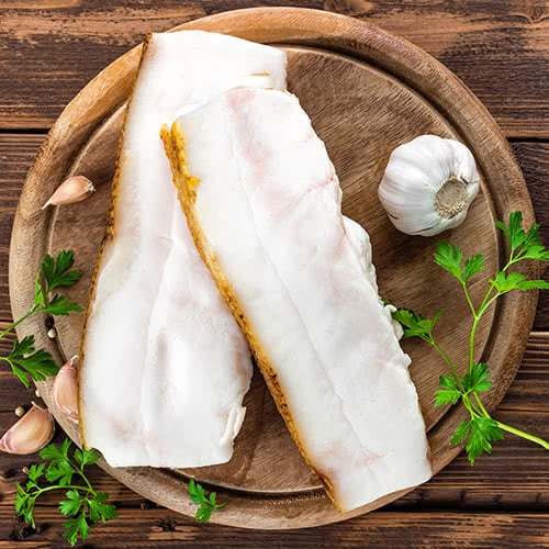 two strips of lard on a wood plate