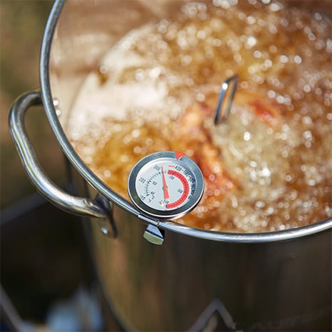 Oil bowling in a stock pot with a thermometer on the side