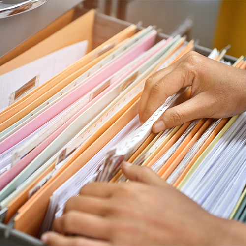 Looking through filing cabinet