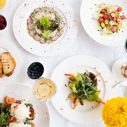 colorful plates of food on white plates on white table