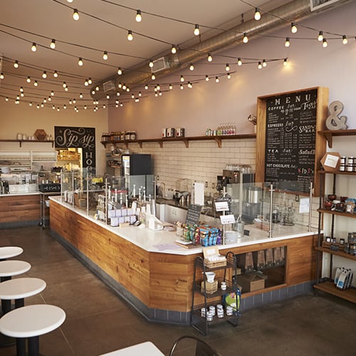 coffee shop counter with string lights overhead