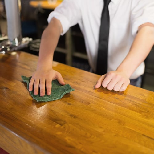 bartender wiping down bartop