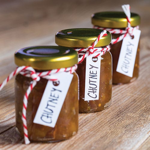 jars of preserved chutney with striped string and labels