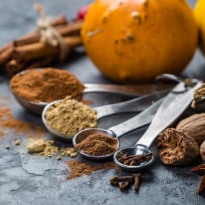 pumpkin pie spice ingredients and spices in measuring spoons