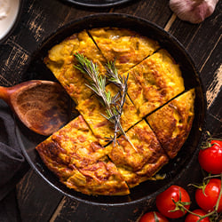 a thick potato omelette in a cast iron pan