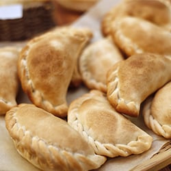 a pile of crescent-shaped empanadas