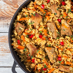 a traditional paella pan filled with seasoned rice