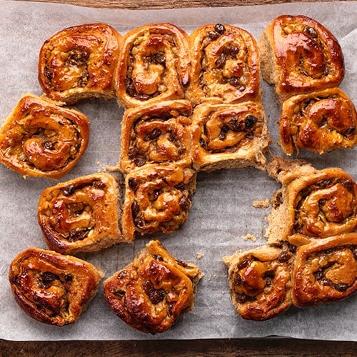 fresh baked chelsea buns
 on a cooling rack