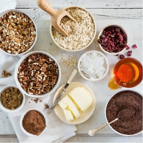 Butter, nuts and other ingredients in bowls on table