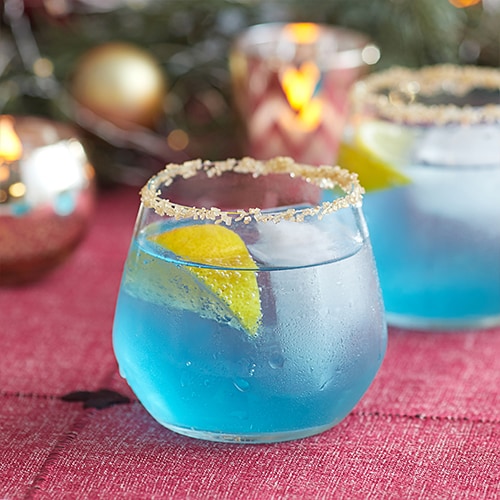  Blue colored cocktail with gold sugar rim