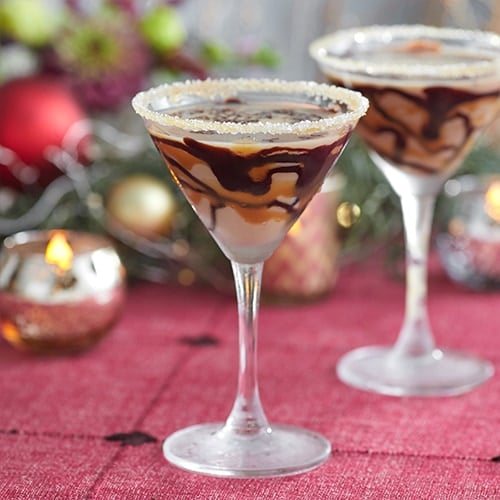 Two martini glasses with a brown salted caramel martini drink.