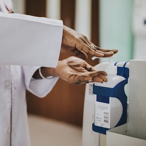 Female Physician sanitizing hands