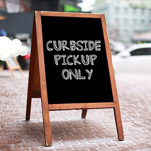 Chalkboard sign outside with Curbside Pickup Only written on it