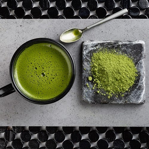 Matcha powder and matcha tea in a bowl