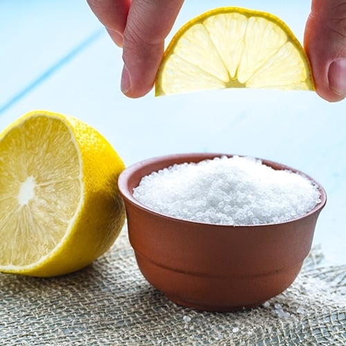 Lemon slice over bowl of citric acid