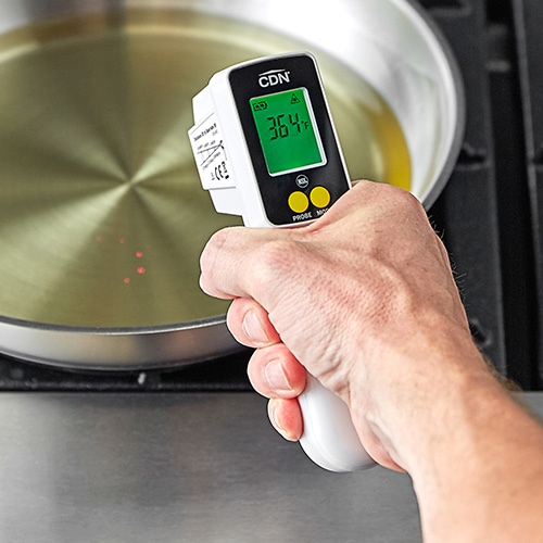 hand holding an infrared thermometer