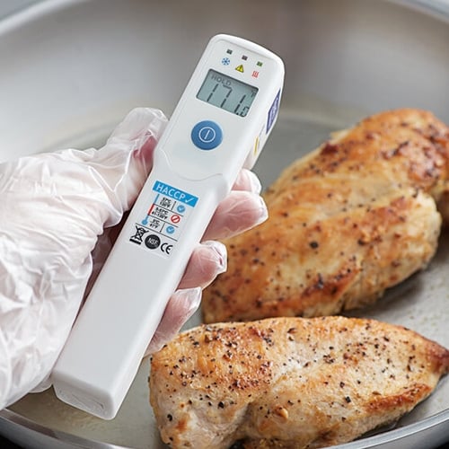 Infrared thermometer taking tempature of chicken