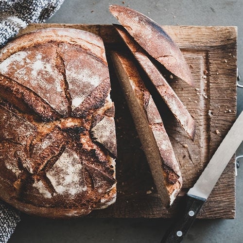 freshly baked sourdough bread loaf with slices