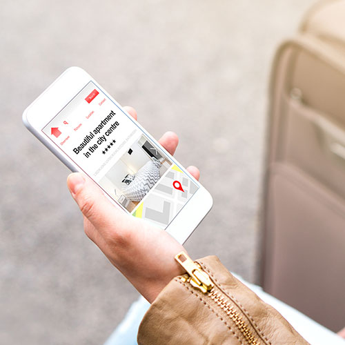 Woman browsing rental locations on a mobile phone