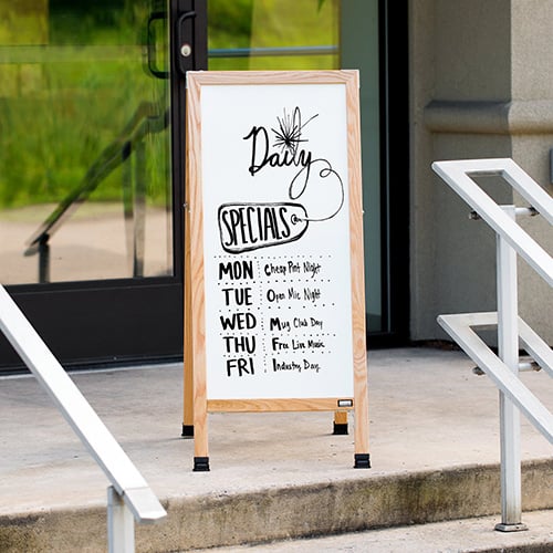 A-frame chalkboard sign with text