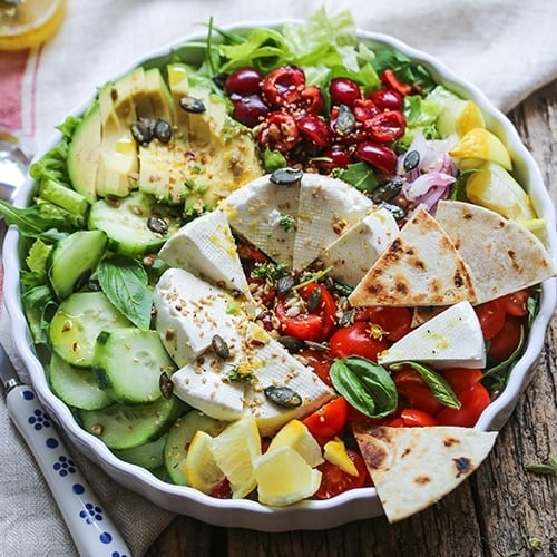 Fresh healthy salad in bowl on counter