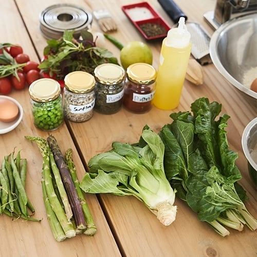 Cooking ingredients laid on wooden counter