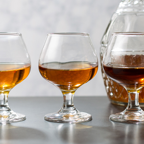 Three different types of brandy in low glasses