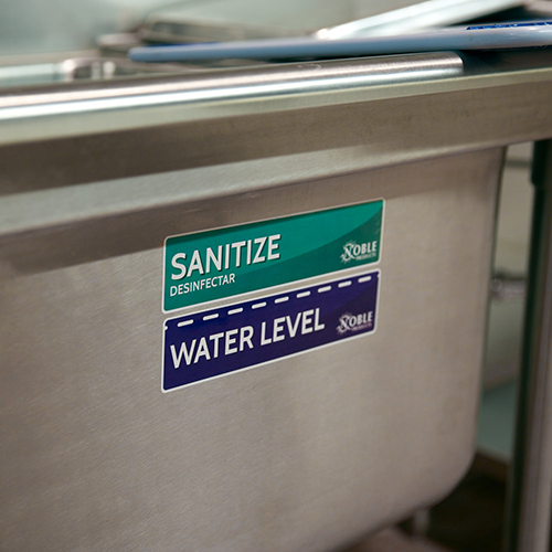 close up of sanitizer label on the third sink of a three compartment sink