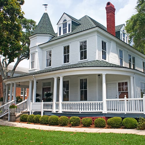 Victorian-Style Home Surrounded By Bushes