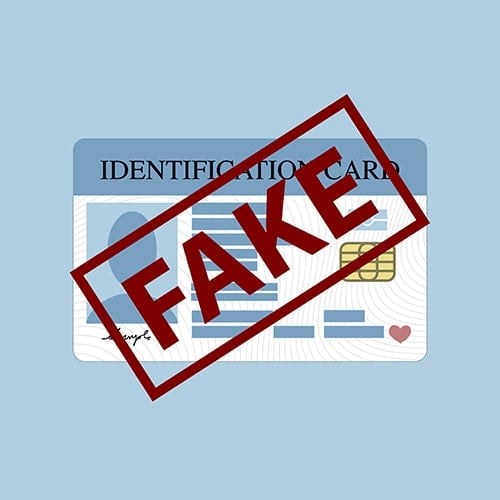 identification card stamped with fake in large letters