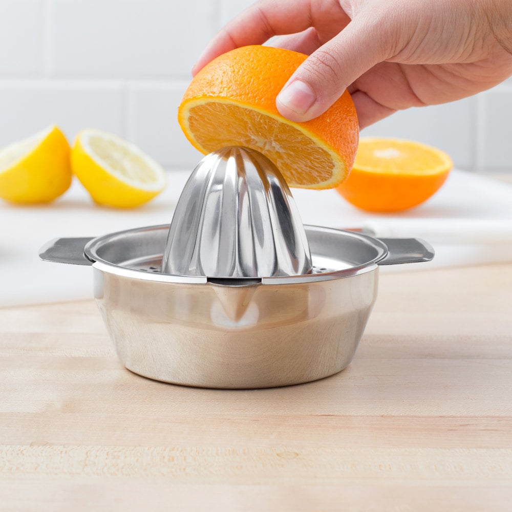 Juicing an orange with a stainless steel juicer