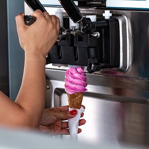 preparation of sweet refreshing ice cream from ice cream machine during summer day