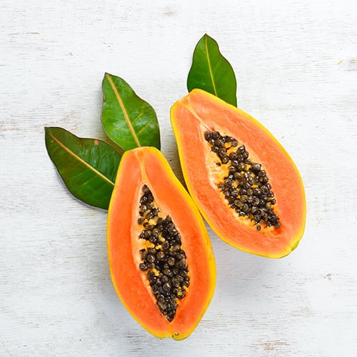 sweet ripe fresh papaya on a white wooden background