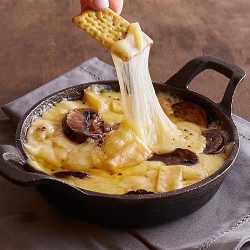 baked gruyere cheese in small cast iron pan