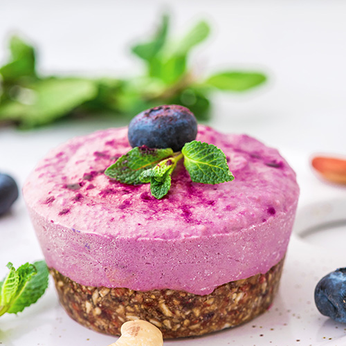 acai cashew cake with berries mint and nuts