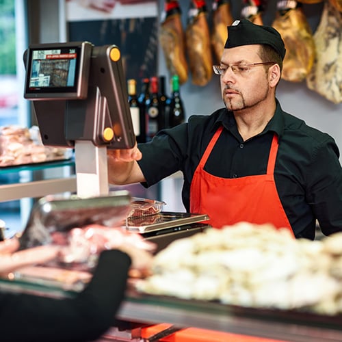 butcher attending a customer in a butcher shop