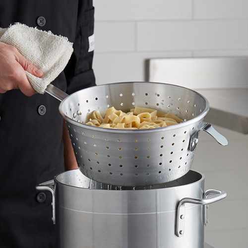 draining pasta in colander into stainless steel pot