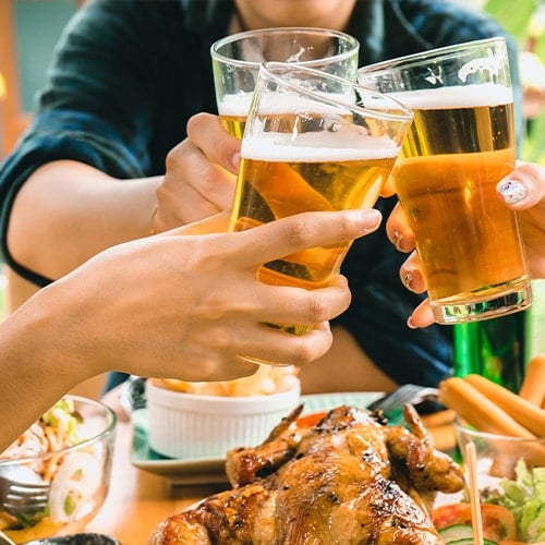 people holding beer glasses together