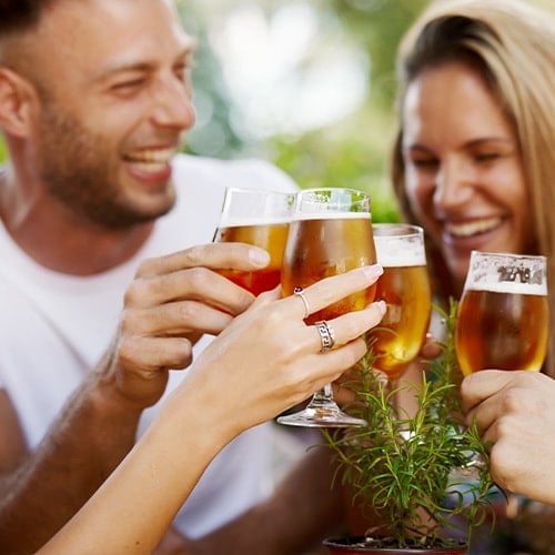 people getting ready to drink from beer glasses