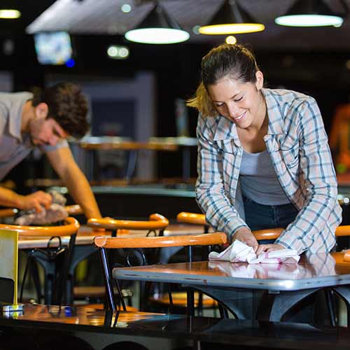 waiters cleaning the tables in restaurant