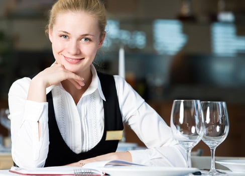 Bartender sitting with two empty wine glasses