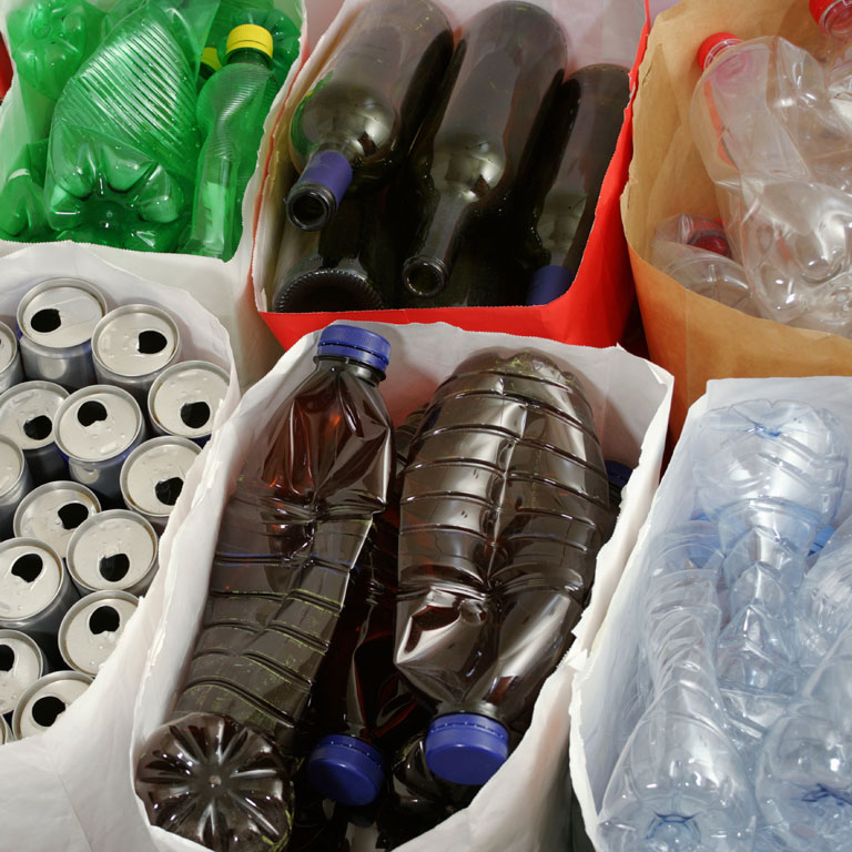 plastic bottles and aluminum cans in recycle bins