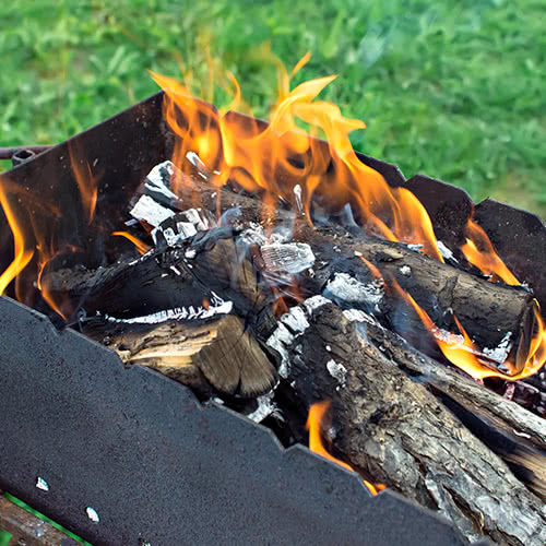Wood logs on fire in firepit