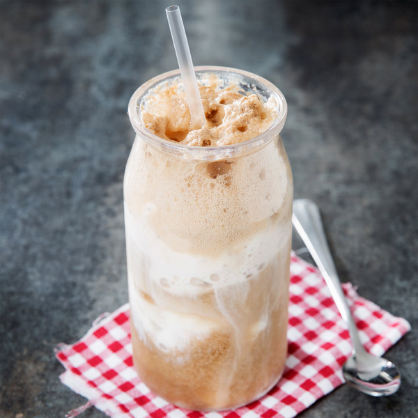 Milkshake in a plastic jar on top of a red checkered napkin