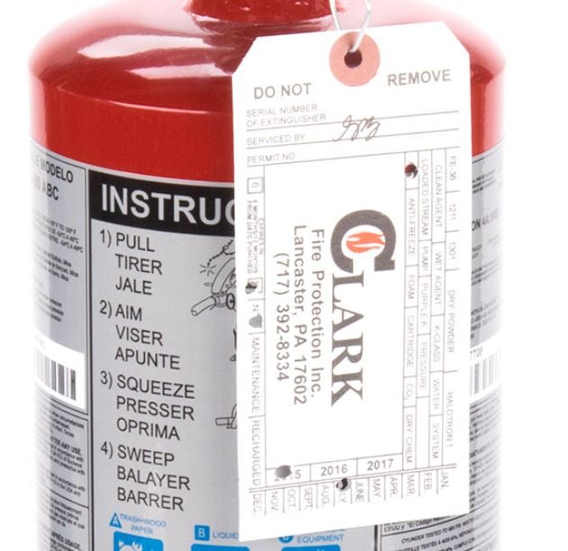 Clark Fire Protection tag on red fire extinguisher