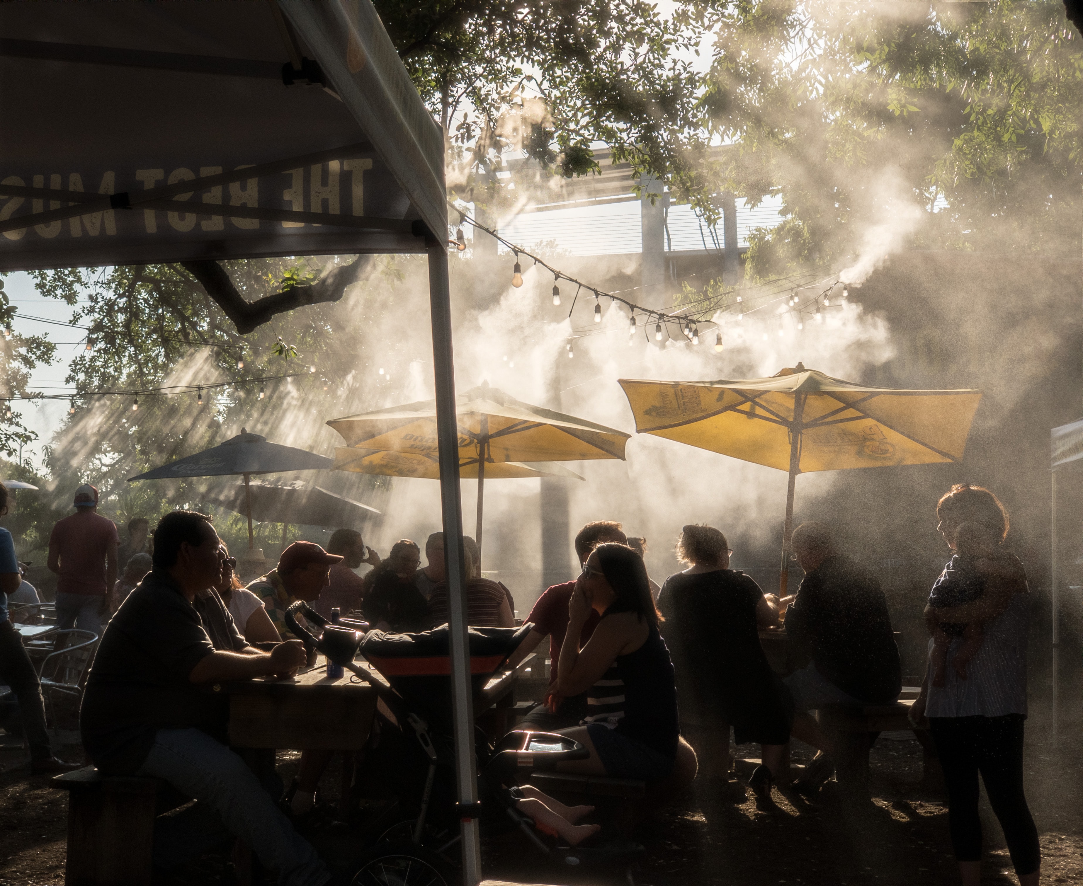 Misty patio with restaurant umbrellas and hanging lights
