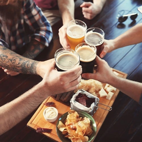 friends drinking beer around a table