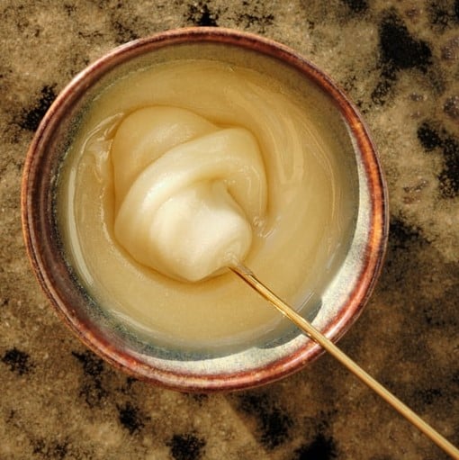 Creamed clover honey on a silver tablespoon
